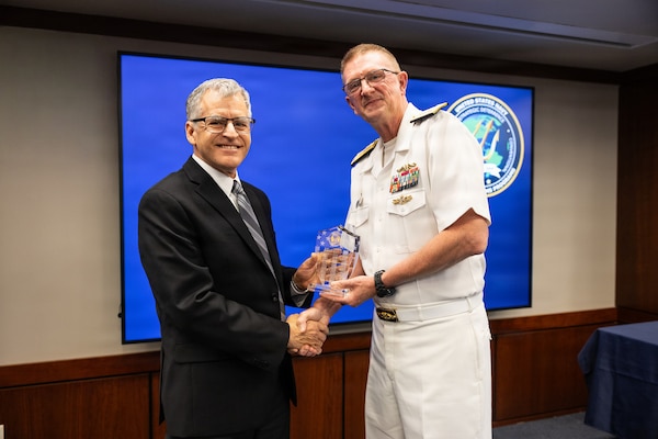 Vice Adm. Johnny Wolfe Jr. (right), director for Portfolio Acquisition Executive (PAE) Strategic Systems Programs (SSP), presents Phillip Robidoux (left), Lockheed Martin Space, with the Fleet Ballistic Missile (FBM) Lifetime Achievement Award in Washington D.C., on May 13, 2026. 

The FBM Lifetime Achievement Award recognizes SSP’s industry partners who demonstrate an unparalleled degree of professionalism and excellence. To date, 121 people have received the award, including this year’s recipients. The FBM Lifetime Achievement Award is sponsored by SSP Historical, Educational and Recognition Organization (HERO), an all-volunteer 501(c) (3) Non-Profit Organization which works to promote awareness and appreciation of the partnership between government and private industry in the development and maintenance of the Navy’s FBM program.