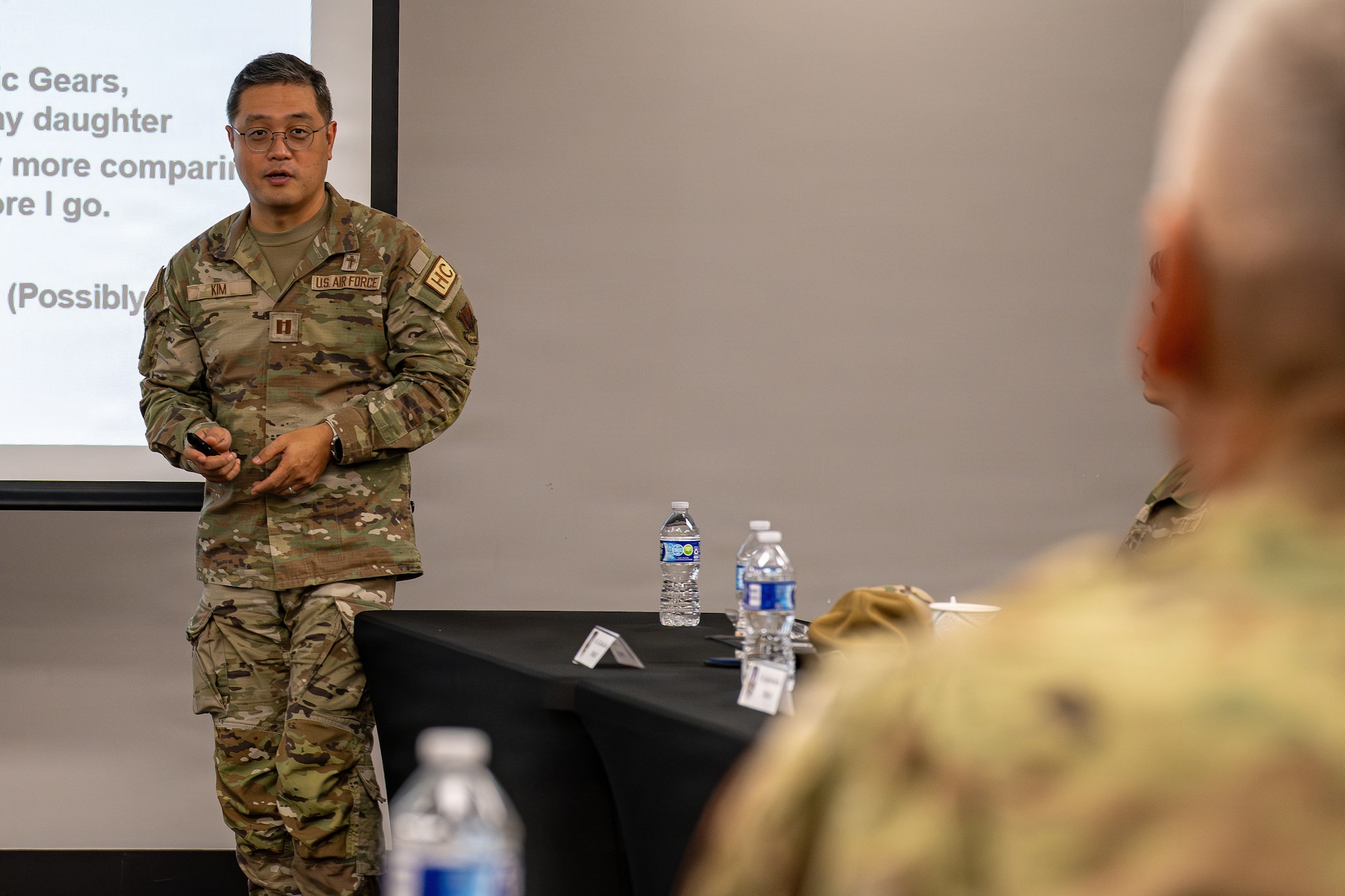 Military member presenting a presentation.