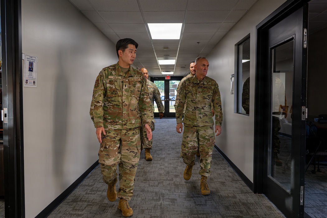 Military members walking down a hallway.