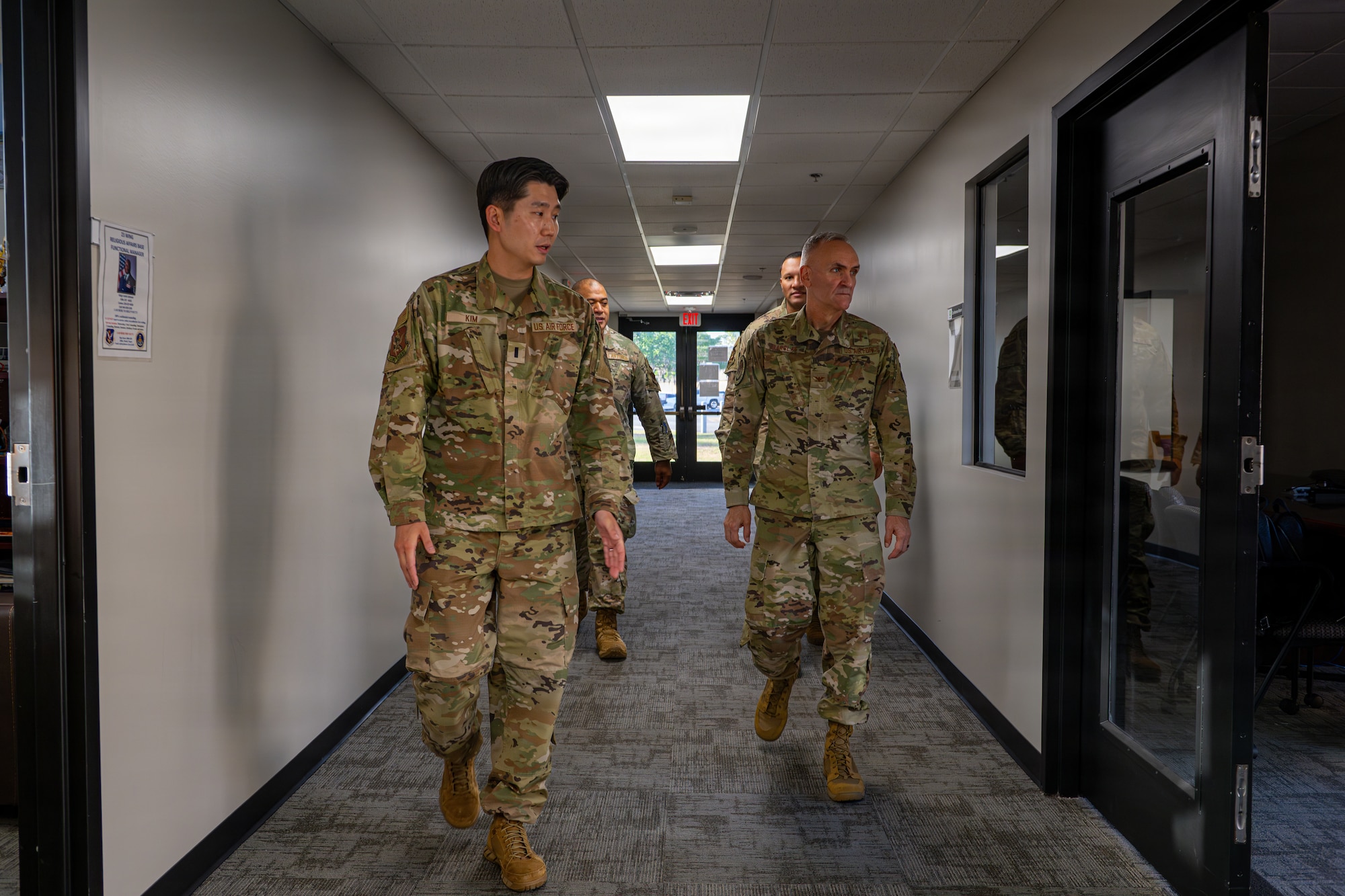 Military members walking down a hallway.