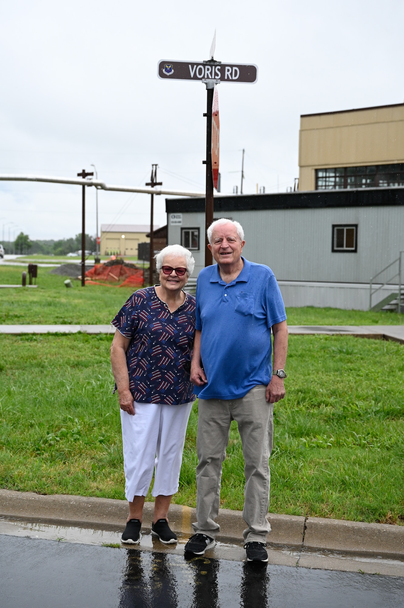 U.S. Air Force 1st Lt. Russel Voris’s siblings, Judy and Paul, pose for a photo in front of the Voris Road street sign at Whiteman Air Force Base, Missouri, May 18, 2026.