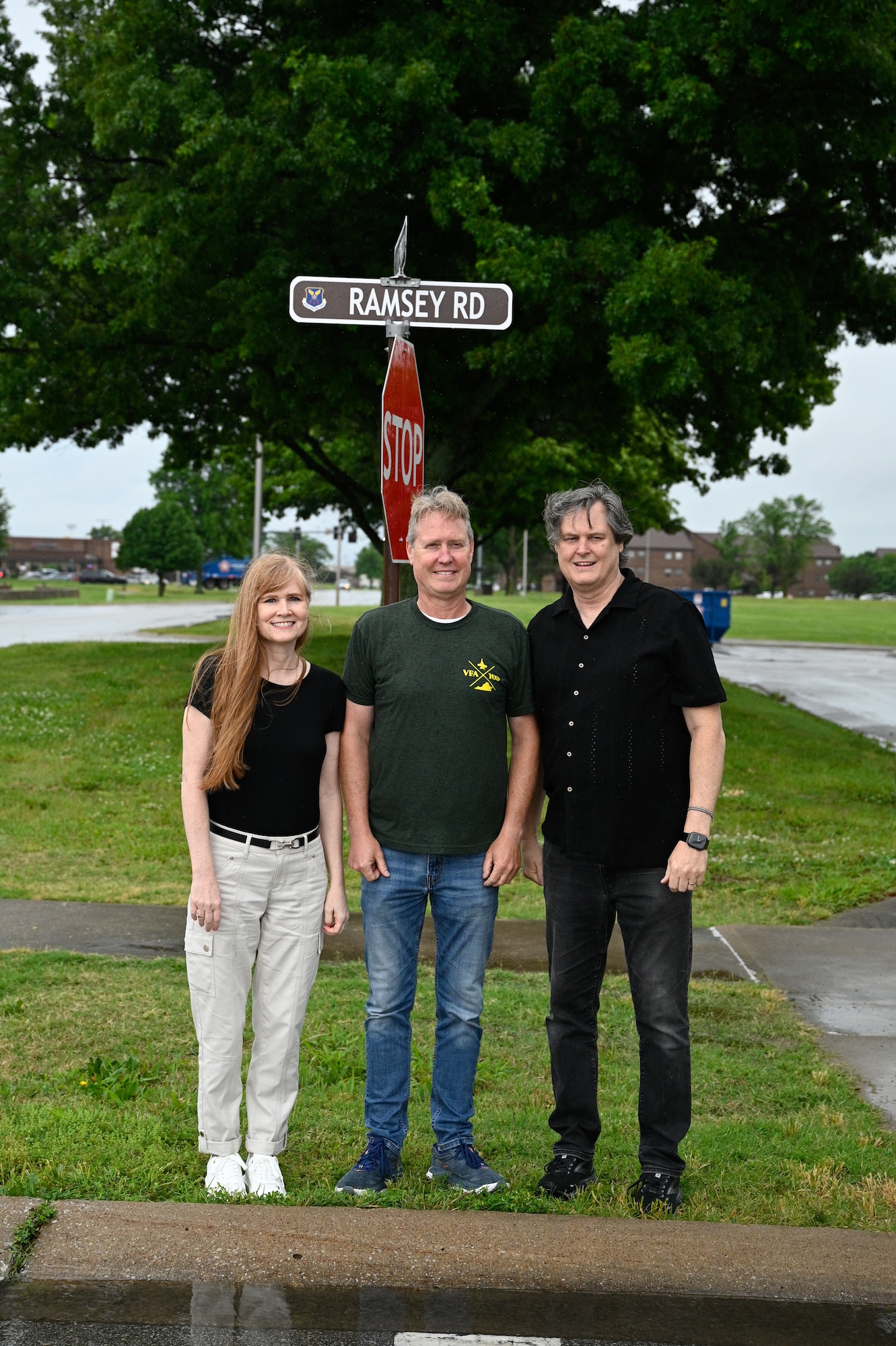 U.S. Air Force Maj. Milton Ramsey's children, Kathleen, Gary and Ron pose for a photo in front of the Ramsey Road street sign at Whiteman Air Force Base, Missouri, May 18, 2026.