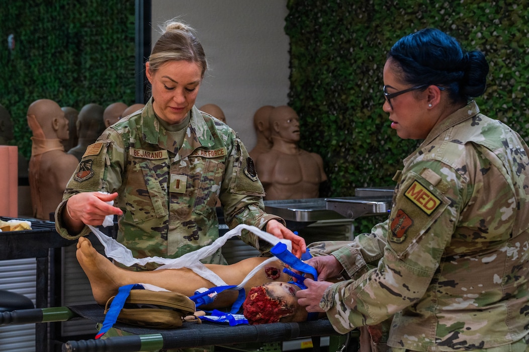 U.S. Air Force 2nd Lt. Kristie Bejarano, 162nd Air National Guard trauma emergency nurse, left, and Tech. Sgt. Dulzaida Lorenzo, 162nd ANG aerospace medical technician, participate in a Tactical Combat Casualty Care training during Nurse and Tech Week observed at Luke Air Force Base, Arizona, May 13, 2026.