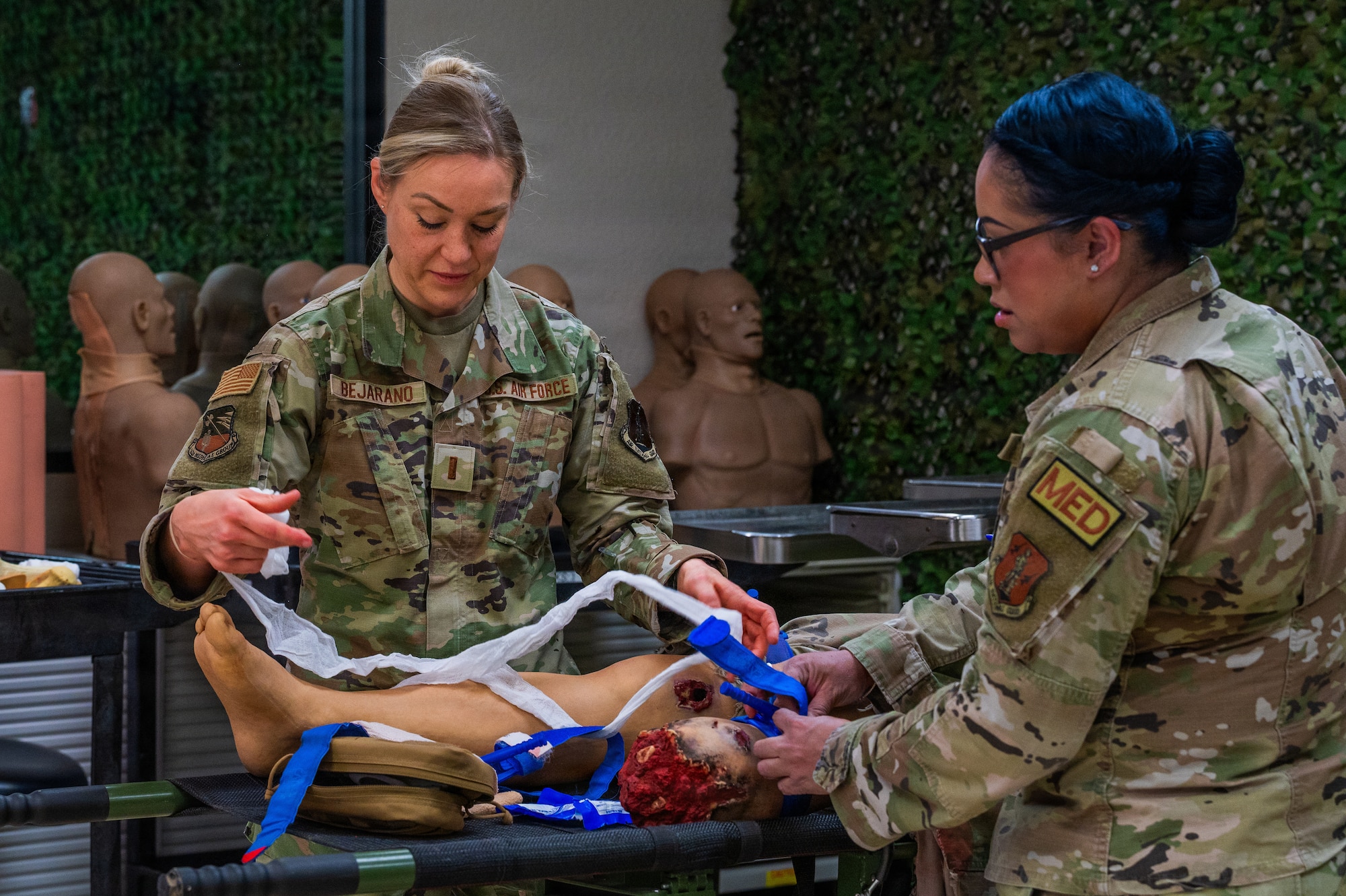 U.S. Air Force 2nd Lt. Kristie Bejarano, 162nd Air National Guard trauma emergency nurse, left, and Tech. Sgt. Dulzaida Lorenzo, 162nd ANG aerospace medical technician, participate in a Tactical Combat Casualty Care training during Nurse and Tech Week observed at Luke Air Force Base, Arizona, May 13, 2026.