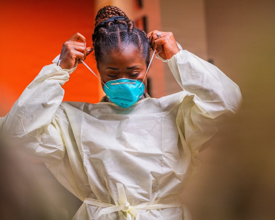 U.S. Air Force Airman 1st Class Salamatu Sesay, Luke Medical Group Healthcare Operations Squadron family health medical technician, dons protective equipment during Nurse and Tech Week observed at Luke Air Force Base, Arizona, May 13, 2026.