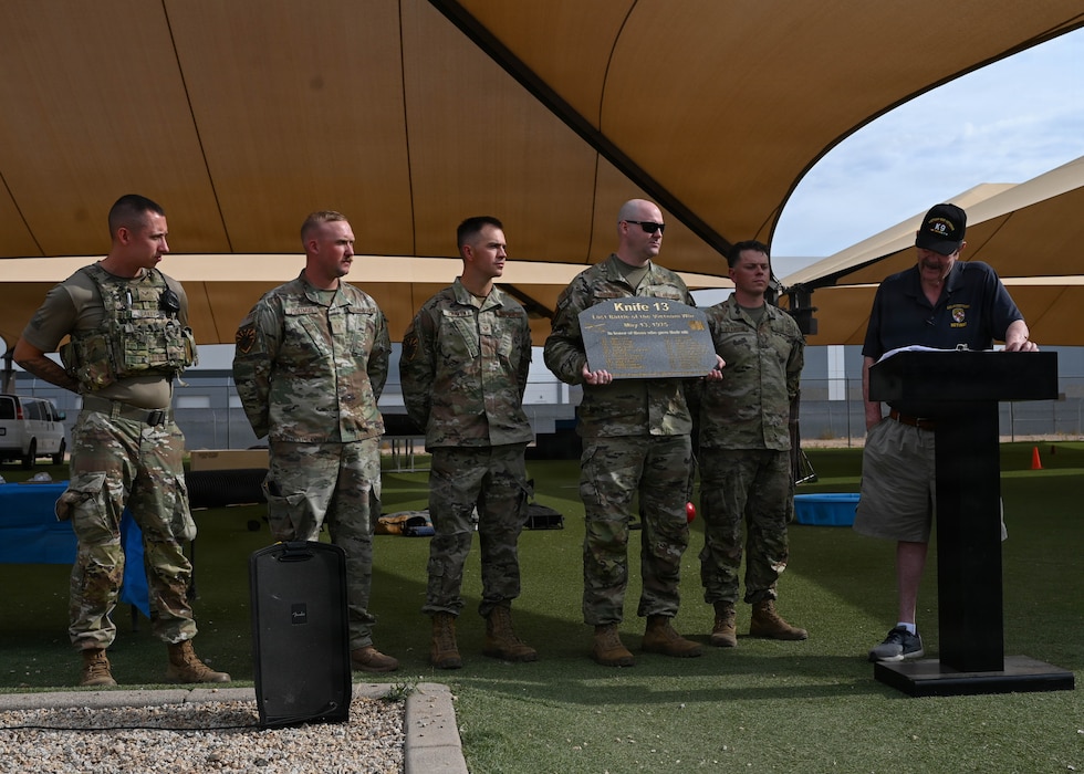 Bill Cummings, a long-standing law enforcement expert, presents a commemorative plaque to the 56th Security Forces Squadron military working dog section during 2026 Police Week held at Luke Air Force Base, Arizona, May 13, 2026. The event aligned with National Police Week 2026, an annual event observed by civilian and military law enforcement entities, to honor tradition, precision, and the spirit of service of law enforcement members in support of the partnerships and communities they serve. (U.S. Air Force photo by Airman 1st Class Rebecca Wagner)