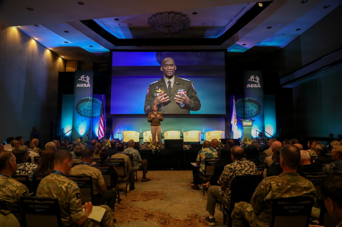 U.S. Army Gen. Xavier T. Brunson delivers a keynote address at the LANPAC Symposium in Honolulu, Hawaii, on May 12, 2026, standing at a podium with event signage and attendees visible in the background.