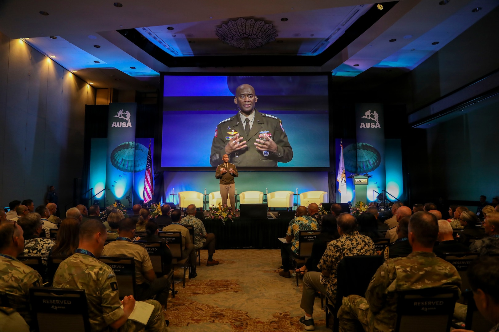 U.S. Army Gen. Xavier T. Brunson stands at a podium delivering a keynote address during the LANPAC Symposium in Honolulu, Hawaii, on May 12, 2026. Event signage and attendees are visible in the background at the professional development forum.