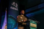 U.S. Army Gen. Xavier T. Brunson stands at a podium delivering a keynote address during the LANPAC Symposium in Honolulu, Hawaii, on May 12, 2026. Event signage is in the background at the professional development forum.