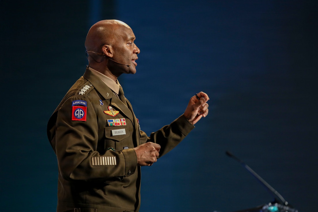 U.S. Army Gen. Xavier T. Brunson stands at a podium delivering a keynote address during the LANPAC Symposium in Honolulu, Hawaii, on May 12, 2026, with event signage and attendees visible in the background.