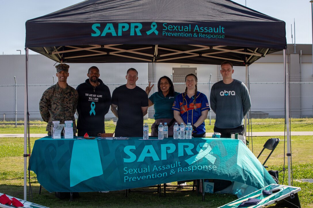 Sexual Assault Prevention and Response Victim Advocates with Marine Aircraft Group 12, 1st Marine Aircraft Wing, pose for a photo during the 2026 You Are Not Alone 24-hour walk aboard Marine Corps Air Station Iwakuni, Yamaguchi, Japan, April 16, 2026. SAAP Month is annually held in April aimed to raise public awareness about sexual violence, educate individuals and communities on how to prevent sexual assault, support survivors, and advocate for change. (U.S. Marine Corps photo by Cpl. Alejandra Vega)