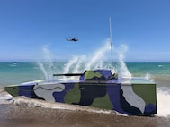 The U.S. Indo-Pacific J7 Pacific Multi-Domain Training and Experimentation Capability team preps an advanced unmanned maritime drone for counter-landing live-fire exercise with soldiers assigned to 2nd Battalion, 35th Infantry Regiment, 3rd Mobile Brigade, 25th Infantry Division, the Armed Forces of the Philippines and the Japan Ground Self-Defense Force during Exercise Balikatan 2026 at La Paz Sand Dunes, Laoag City, Philippines, May 4, 2026.
