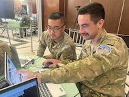 U.S. Army Spc. Justin Xu, 1st Multi-Domain Effects Battalion, and New Zealand Army Lance Cpl. Liam Van Der Mespel, 1st Command Support Regiment, analyze data for Blue Team 6 during the Balikatan 2026 cyber defense exercise at Camp Aguinaldo, Philippines, April 29, 2026.