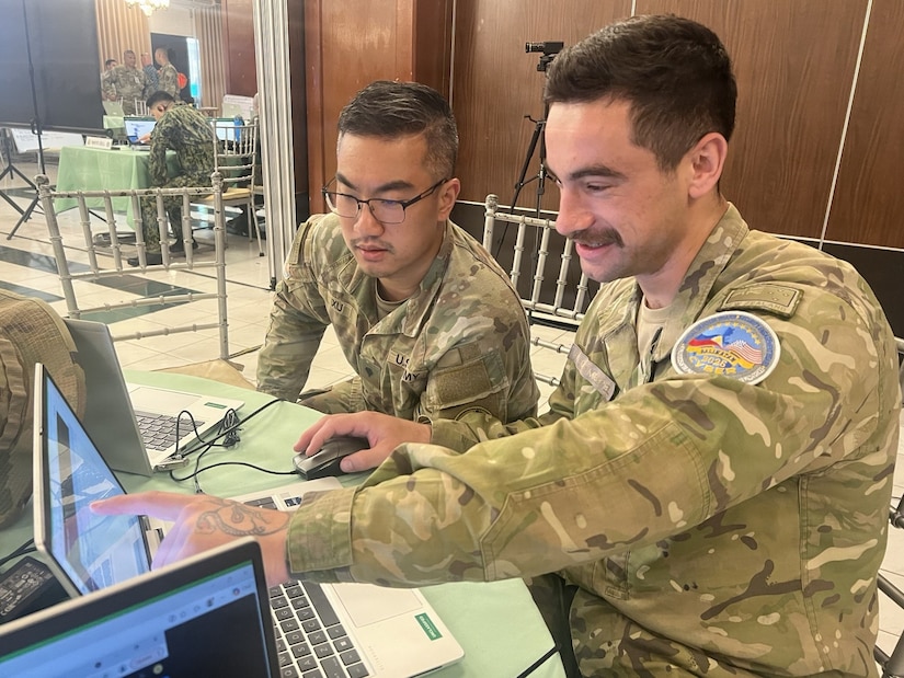 U.S. Army Spc. Justin Xu, 1st Multi-Domain Effects Battalion, and New Zealand Army Lance Cpl. Liam Van Der Mespel, 1st Command Support Regiment, analyze data for Blue Team 6 during the Balikatan 2026 cyber defense exercise at Camp Aguinaldo, Philippines, April 29, 2026.