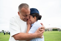 Airman Bryanna Garcia is embraced by her father Jacob Garcia after graduating from the Basic Military Training, May 7, 2026. Airman Garcia’s father served as a Partner Nation Instructor at the at the Inter-American Air Forces Academy in 2006 for two years. Garcia was born in the U.S. and was inspired to follow in her father’s footsteps working in aviation maintenance. (U.S. Air Force photo by Vanessa R. Adame)