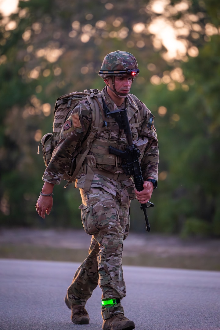 Master Sgt. Jesus Cintron, 320th Training Squadron, during a 12-mile ruck march while carrying a 35-pound dry load, an Advanced Combat Helmet, Tactical Assault Panel, and his rifle during the Joint Warrior Competition at Fort Jackson, South Carolina, April 20, 2026. (Photo by Sgt. 1st Class Dana Clarke)