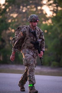 Master Sgt. Jesus Cintron, 320th Training Squadron, during a 12-mile ruck march while carrying a 35-pound dry load, an Advanced Combat Helmet, Tactical Assault Panel, and his rifle during the Joint Warrior Competition at Fort Jackson, South Carolina, April 20, 2026. (Photo by Sgt. 1st Class Dana Clarke)