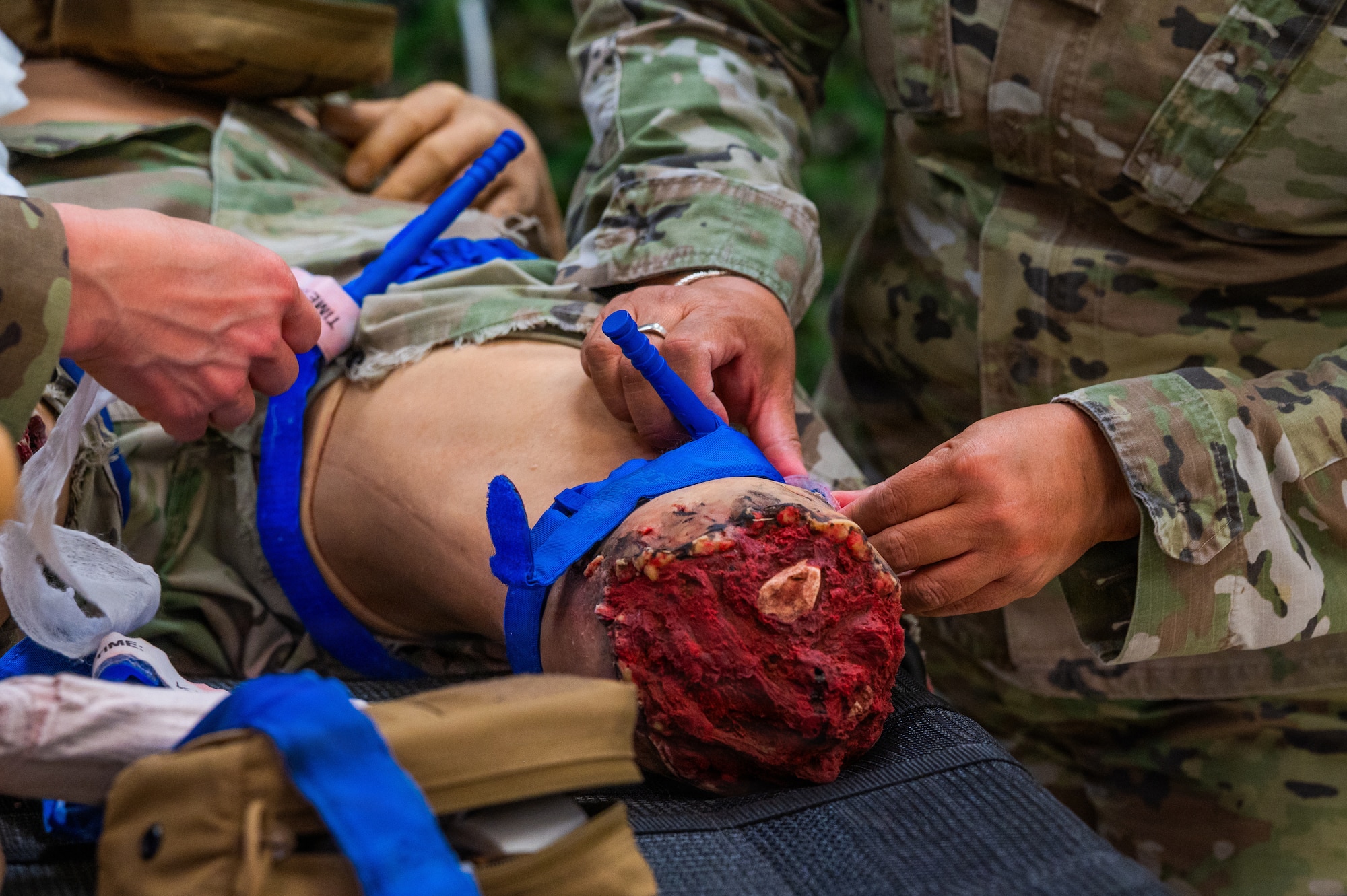 A U.S. Airman places a tourniquet on a trauma manikin simulator during a Tactical Combat Casualty Care training held at Luke Air Force Base, Arizona, May 13, 2026.