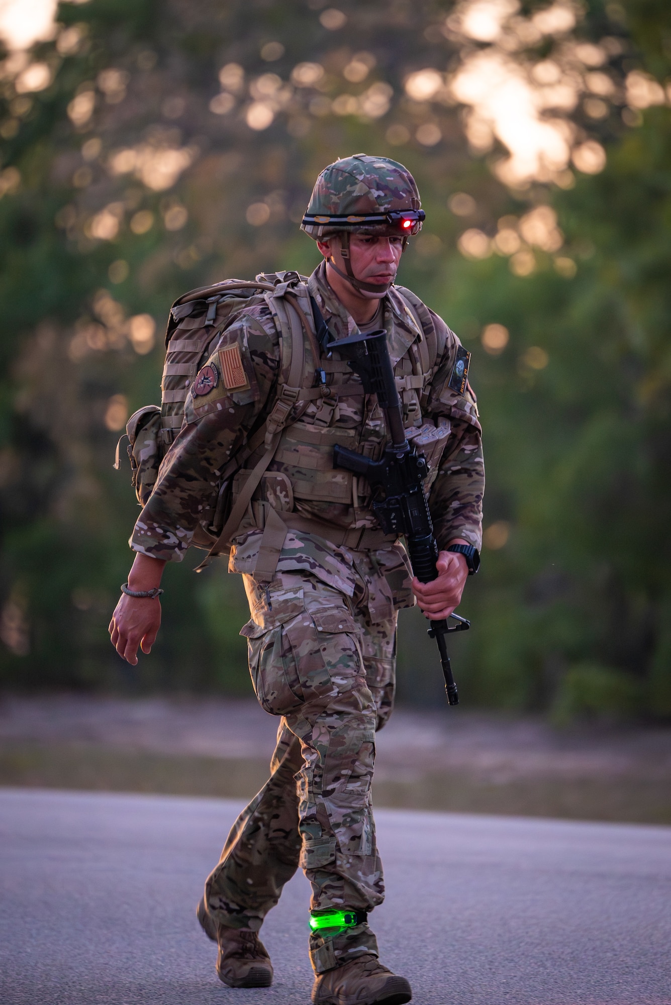 Master Sgt. Jesus Cintron, 320th Training Squadron, during a 12-mile ruck march while carrying a 35-pound dry load, an Advanced Combat Helmet, Tactical Assault Panel, and his rifle during the Joint Warrior Competition at Fort Jackson, South Carolina, April 20, 2026. (Photo by Sgt. 1st Class Dana Clarke)