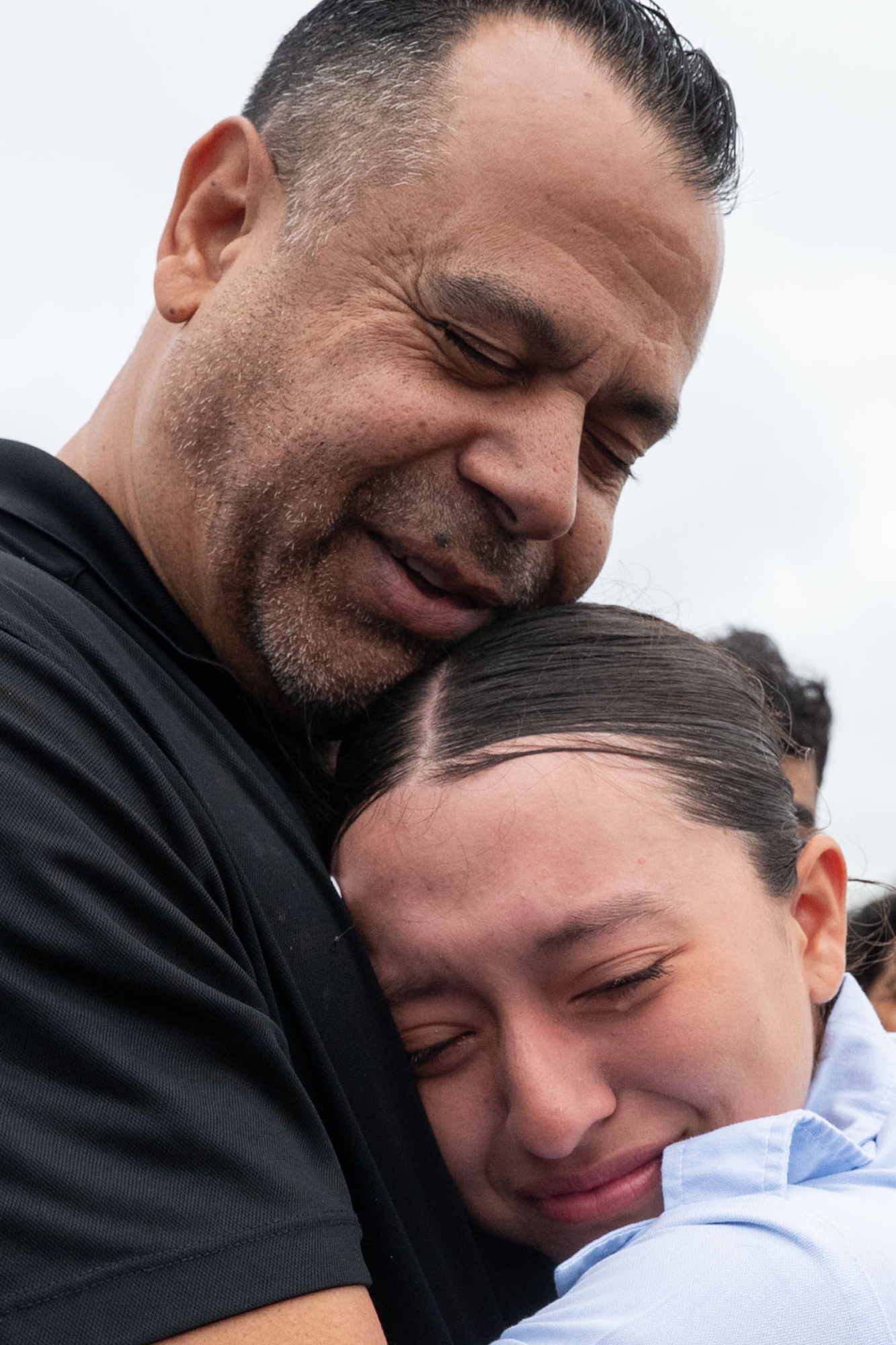 Franciso Hernandez of the Inter-American Air Forces Academy rests his head on Airman Bryanna Garcia after the graduation ceremony from Basic Military Training, May 7, 2026. Her father Jacob Garcia served as a Partner Nation Instructor at the at the Inter-American Air Forces Academy in 2006 for two years. Garcia was born in the U.S. and was inspired to follow in her father’s footsteps working in aviation maintenance. (U.S. Air Force photo by Vanessa R. Adame)