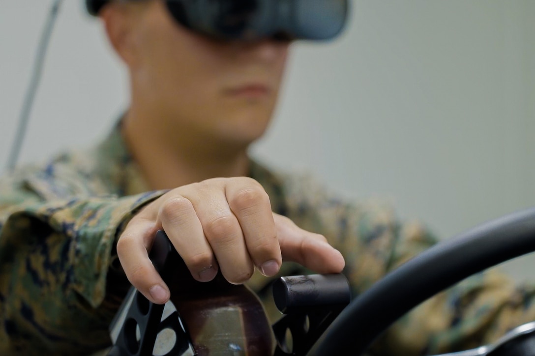 close-up of a Marine's hand using gear shift on ACV simulator