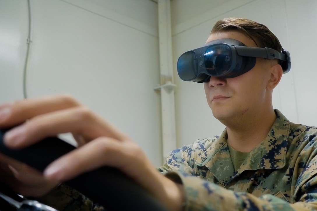 A Marine aboard USS Comstock trains on an Amphibious Combat Vehicle (ACV) while underway on the U.S. Naval vessel, USS Comstock, March 27, 2026. The Marine, deployed with the 11th Marine Expeditionary Unit (MEU), was trained on how to utilize the simulator before operating the real vehicle. (U.S. Marine Corps imagery by Moises Rodriguez)