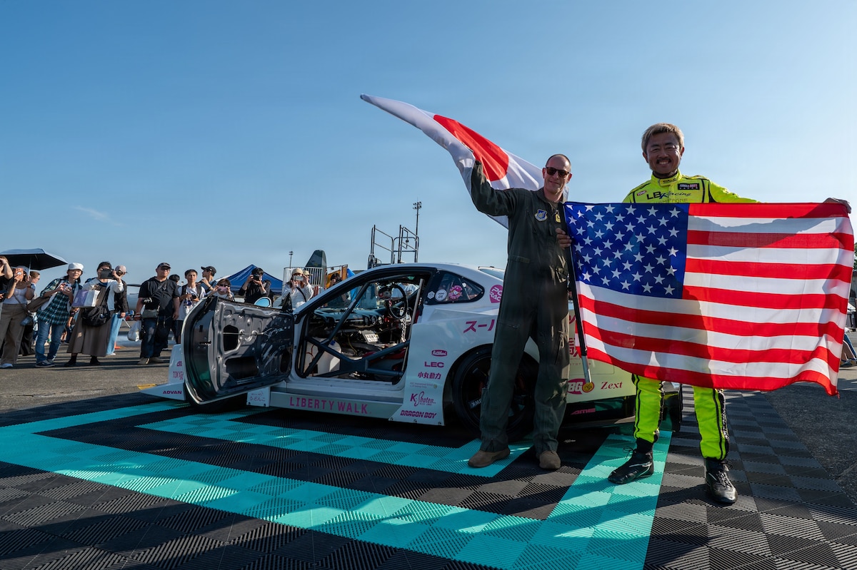 Two people waving national flags together