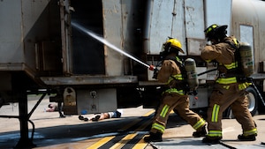 Firefighters assigned to the 51st Civil Engineer Squadron spray water on an aircraft trainer during a major accident response exercise as part of exercise Mustang Rodeo 26-2 at Osan Air Base, Republic of Korea, May 14, 2026.