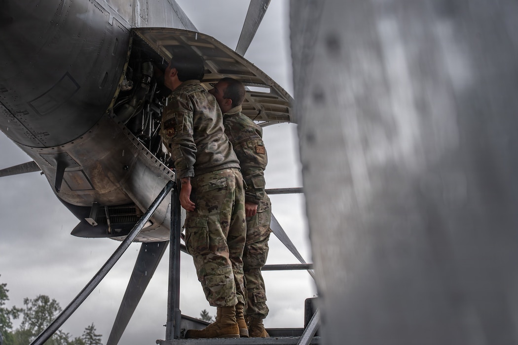 U.S. Air Force Airman 1st Class Andrew Lowe, left, 86th and Airman 1st Class Alejandro Calderon, 86th Aircraft Maintenance Squadron maintainers, complete engine repairs on a C-130J Hercules at Ramstein Air Base, Germany, May 14, 2026.