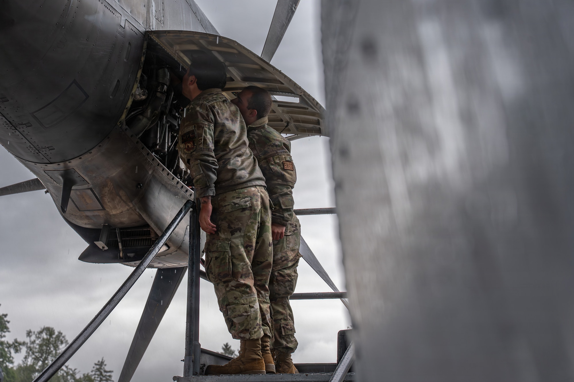 U.S. Air Force Airman 1st Class Andrew Lowe, left, 86th and Airman 1st Class Alejandro Calderon, 86th Aircraft Maintenance Squadron maintainers, complete engine repairs on a C-130J Hercules at Ramstein Air Base, Germany, May 14, 2026.