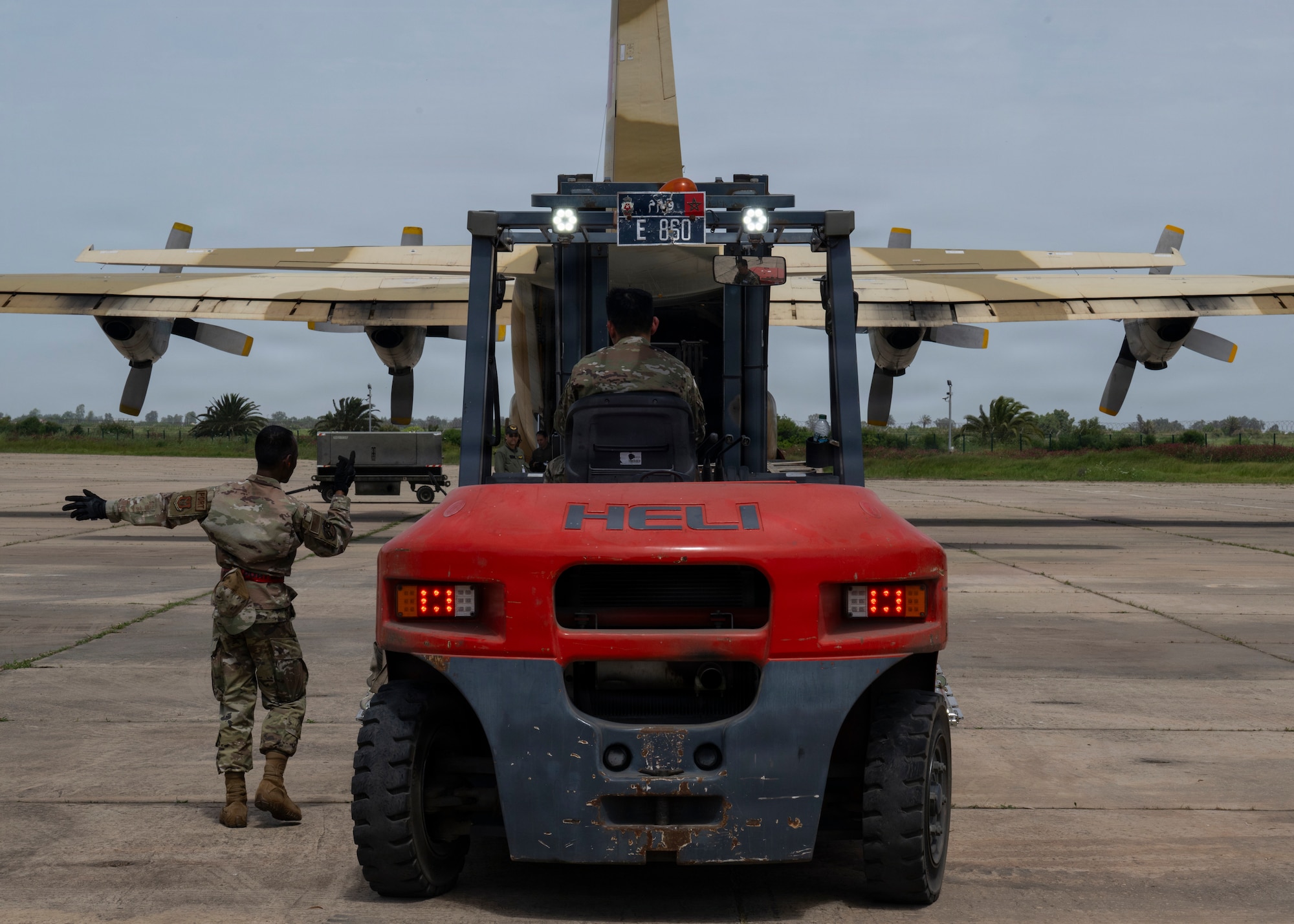 U.S. Air Force Senior Airman Jeffrey Tan, a load joint inspection representative assigned to the 88th Aerial Port Squadron, starts the loading process for engine running on and offloading procedures during Africa Lion 26 at 3rd Royal Moroccan Air Base, Kenitra, Morocco, April 27, 2026.