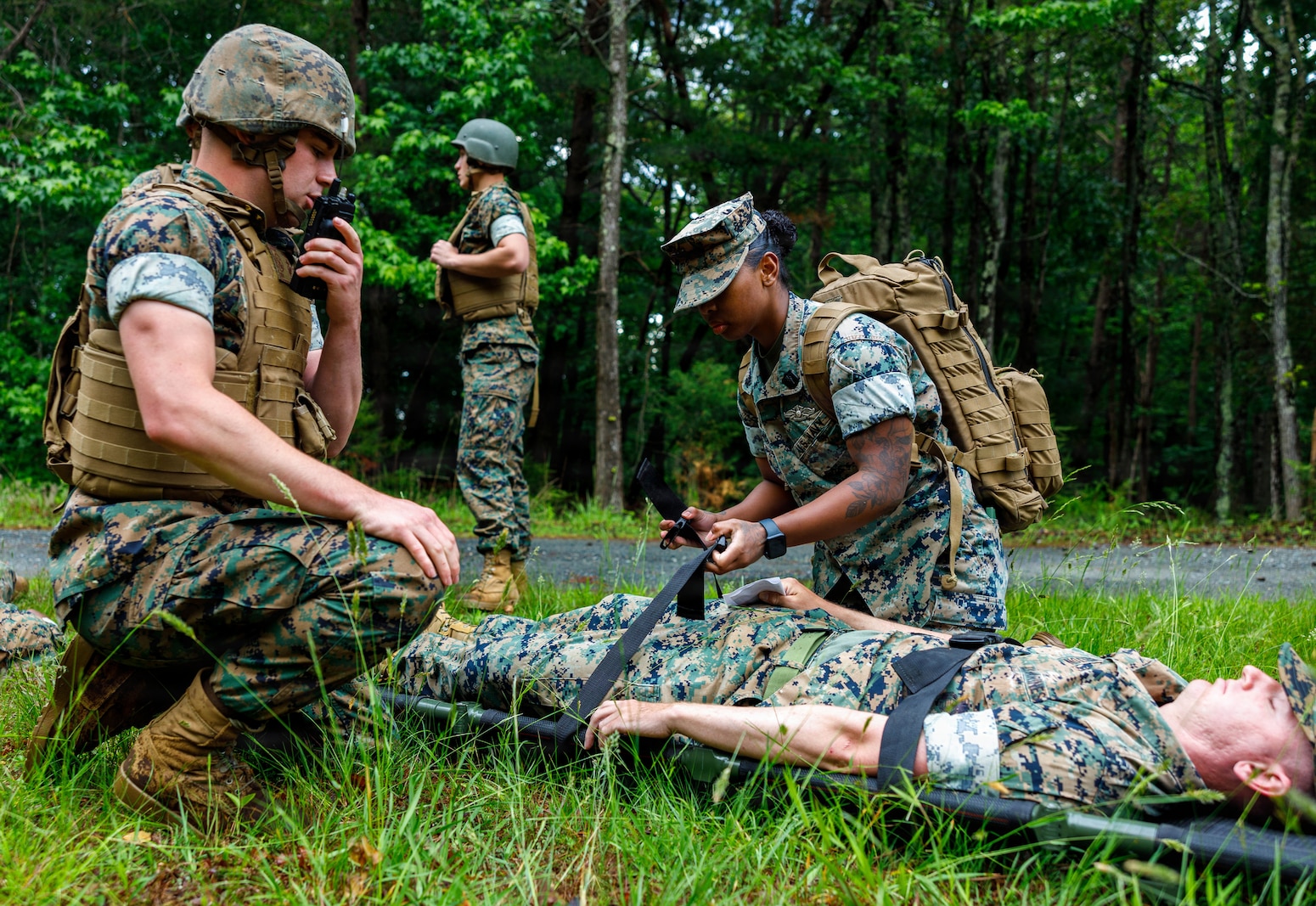 U.S. Navy Hospital Corpsman 3rd Class Naliah Thomas, with Alpha Company Medical Platoon, conducts a casualty evacuation during the Mass Casualty Training Event at the Officer Candidate School on Marine Corps Base Quantico, Virginia, May 14, 2026. The Mass Casualty Training Event consists of several different stations with mock casualties that are tended and taken to the main OCS clinic for additional treatment in order to further qualify hospital corpsman. (U.S. Marine Corps photo by Lance Cpl. Lynsee Avila-Ramirez)