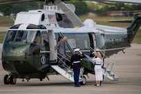 King Charles III exits a helicopter during a departure ceremony.