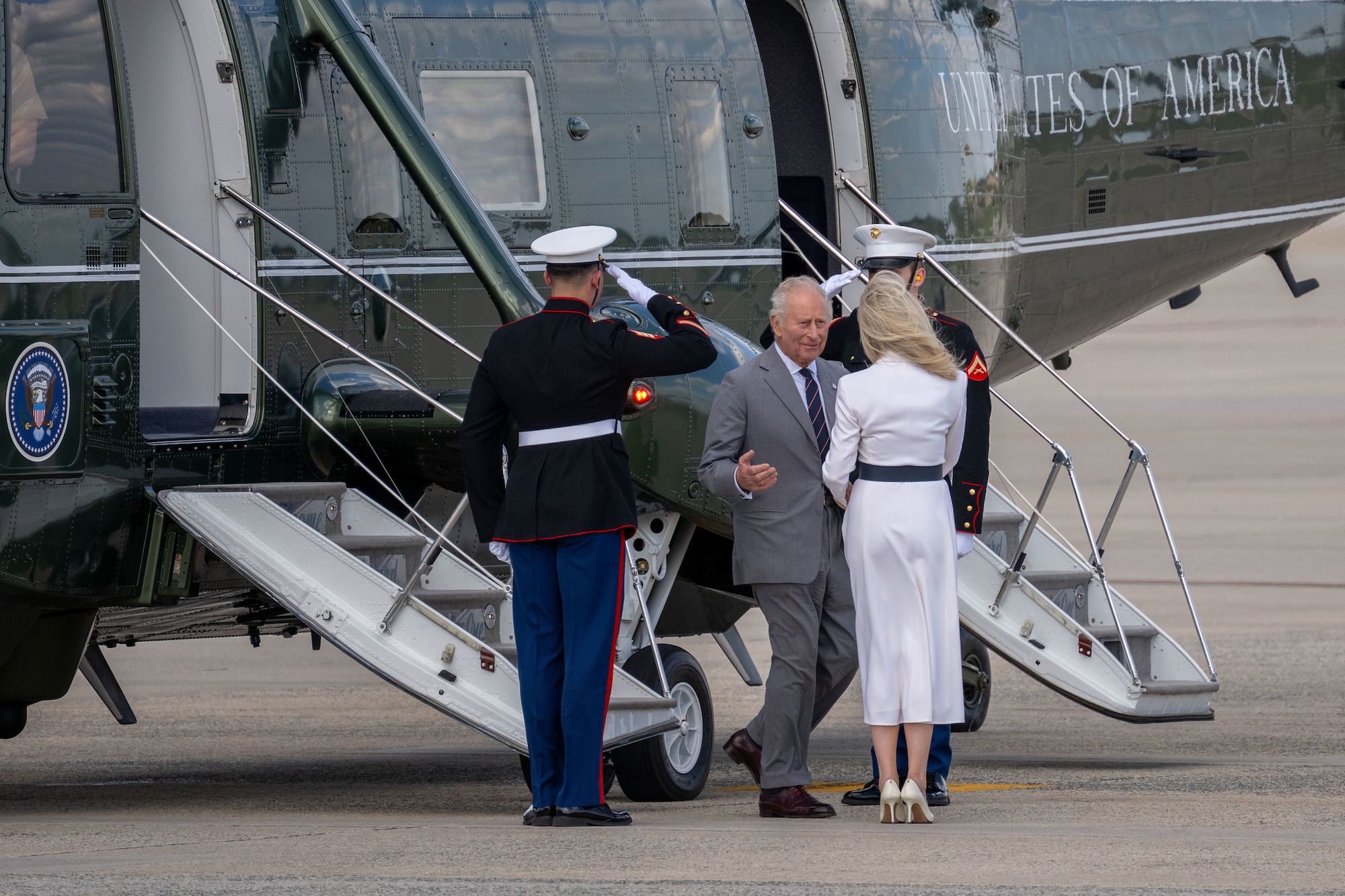 King Charles III exits a helicopter during a departure ceremony.