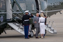King Charles III exits a helicopter during a departure ceremony.