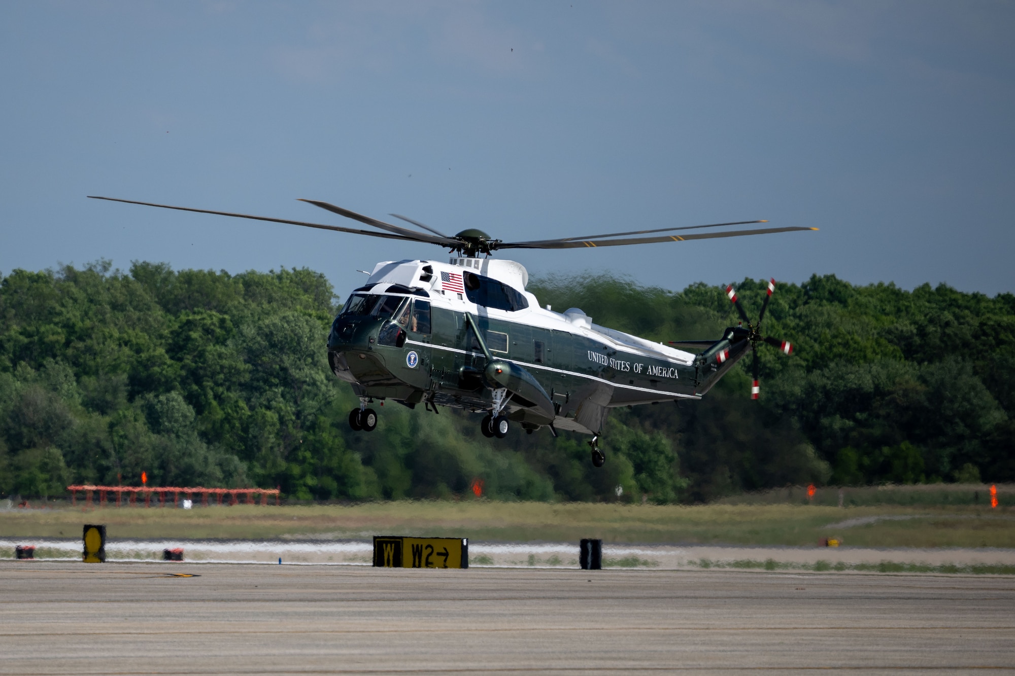 A helicopter lands before a departure ceremony for King Charles III.