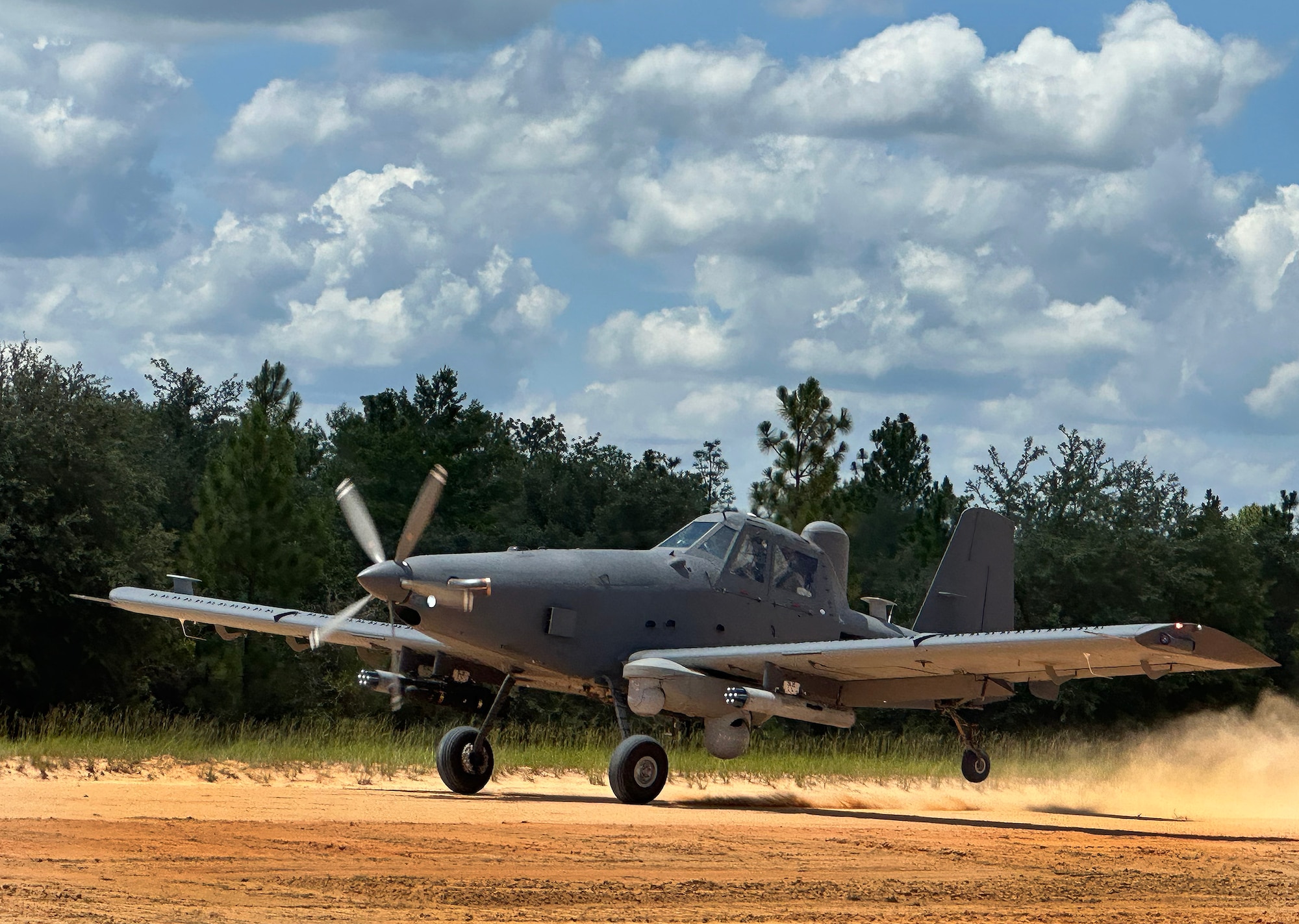 An OA-1K Skyraider II comes in for a landing on a dirt path July 10 on the Eglin Air Force Base.