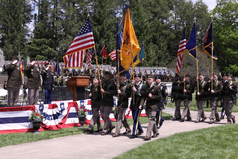 A procession of unit guidons and colors marches toward the reviewing stand at the start of the 28th Infantry Division’s annual memorial service May 17, 2026, in Boalsburg, Pennsylvania. Each year Soldiers from the 28th Infantry Division participate in an annual memorial ceremony at the 28th Division Shrine on the grounds of the Pennsylvania Military Museum in Boalsburg to recognize the fallen and their Gold Star families, along with the strength and honor that comes with the 28th Infantry Division.(U.S. Army National Guard photo by Staff Sgt. Kenneth Shirk)