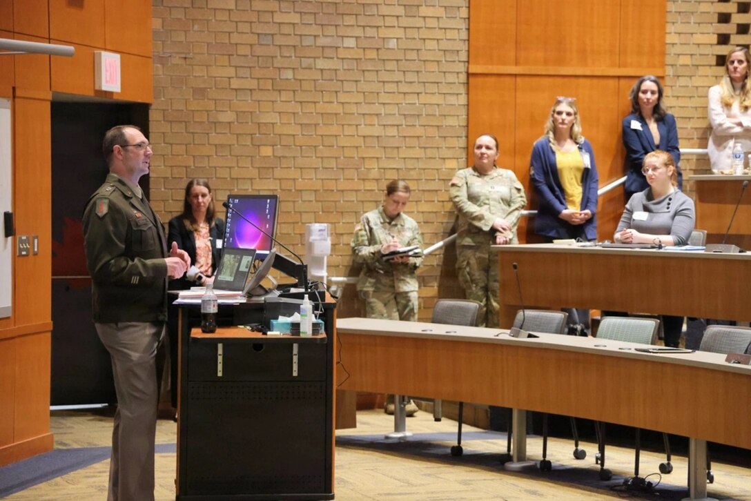 Maj. Gen. Strub presenting to an audience in a lecture hall