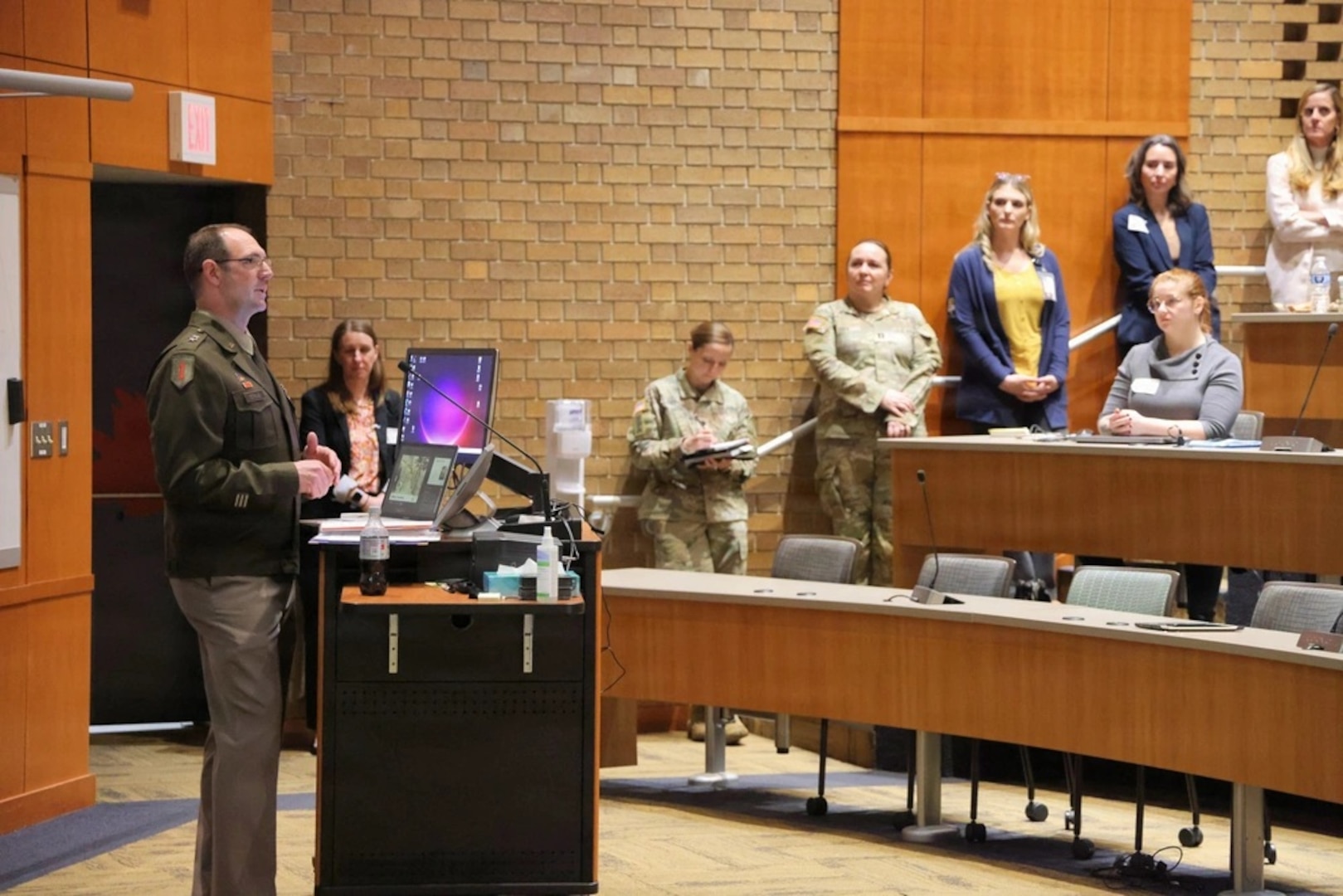 Maj. Gen. Strub presenting to an audience in a lecture hall