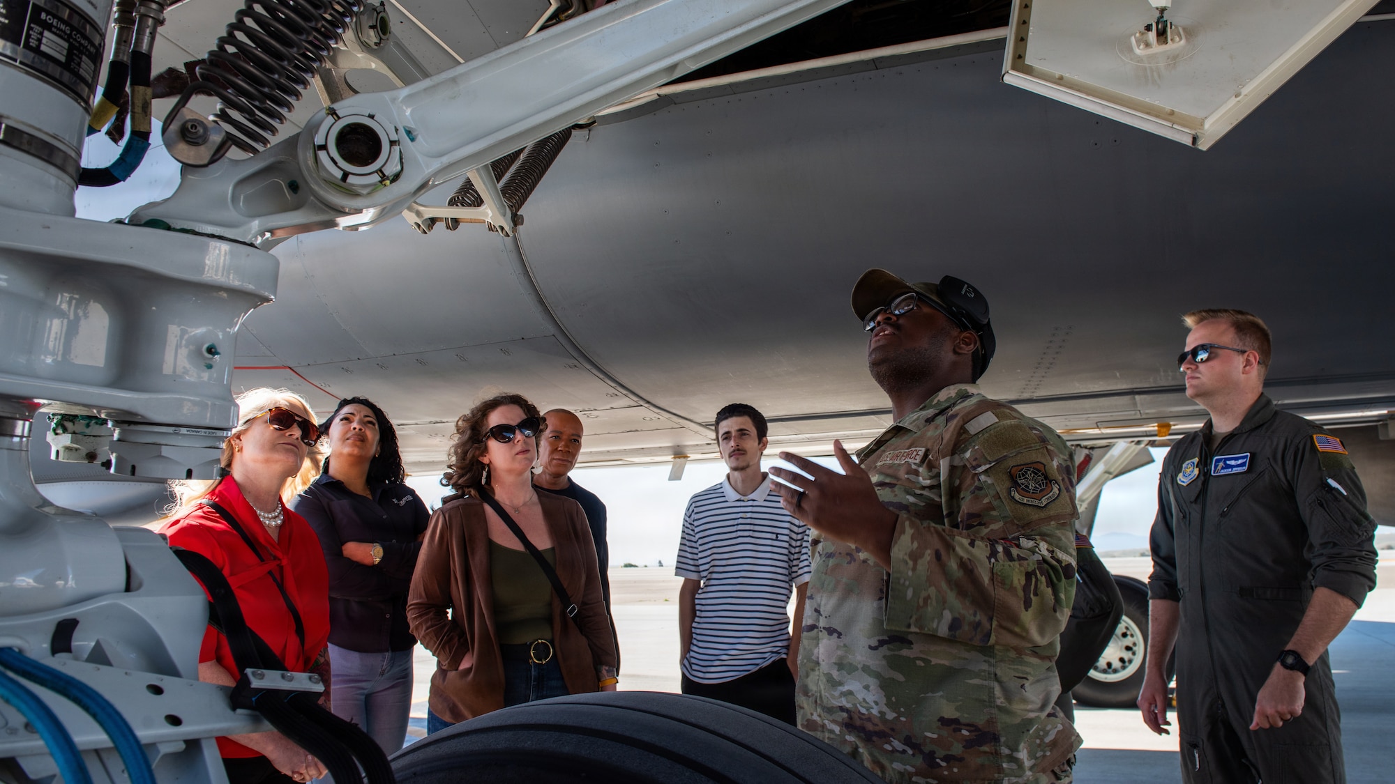 Members of the leadership vacaville program are briefed about an aircraft on the flight line