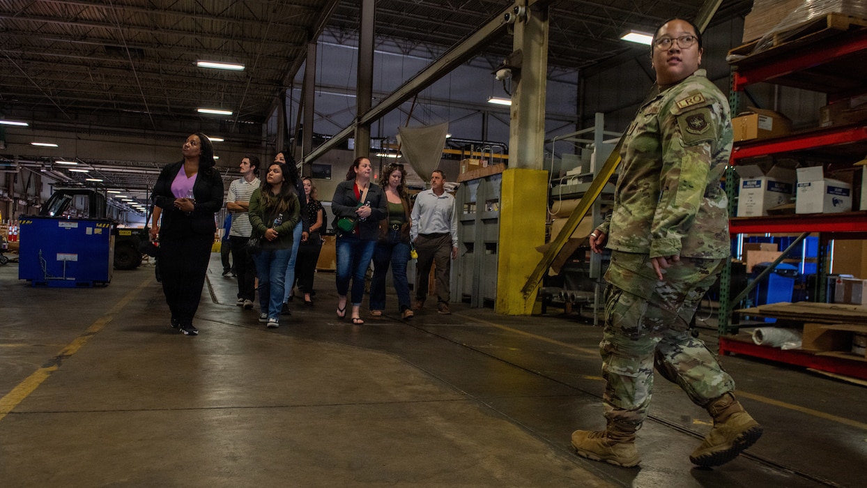 Airman gives tour of aerial port warehouse.