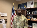 Smiling man wears a camouflage military uniform