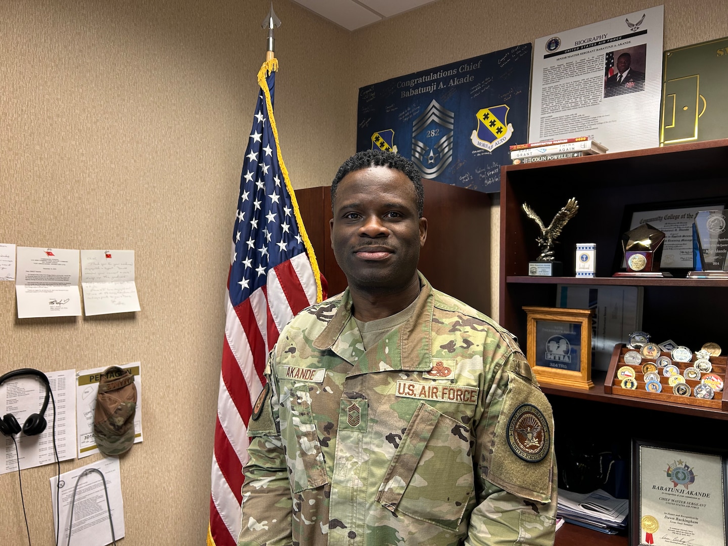 Smiling man wears a camouflage military uniform