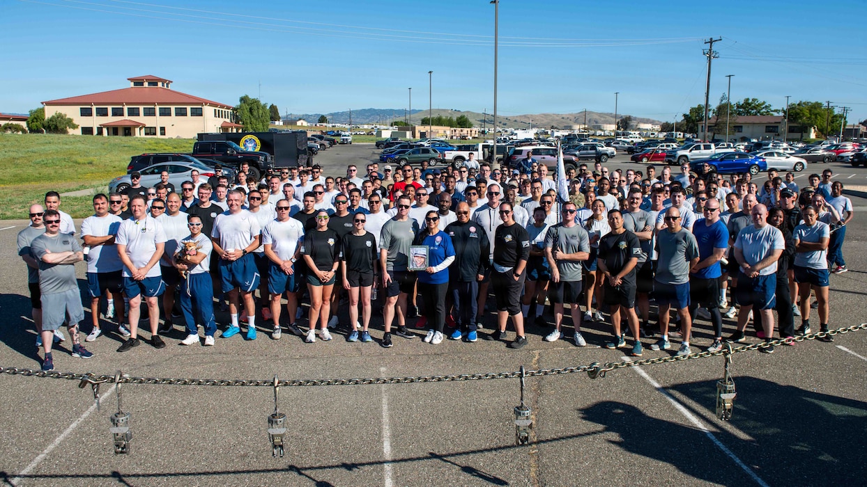 Aerial port Airman gather for group photo with parents of fallen Airman