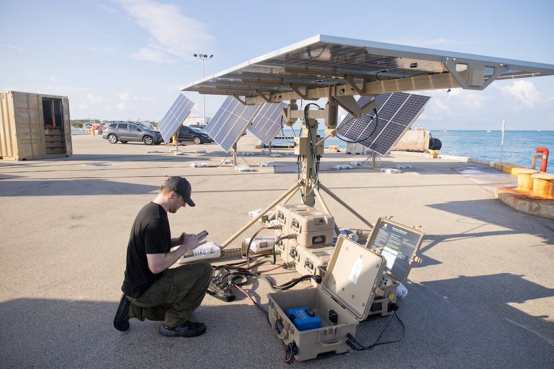 A contractor checks equipment during a military exercise.
