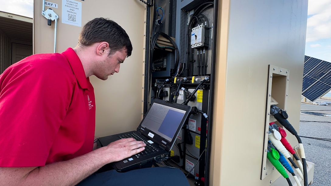 An engineer checks equipment during a military exercise.