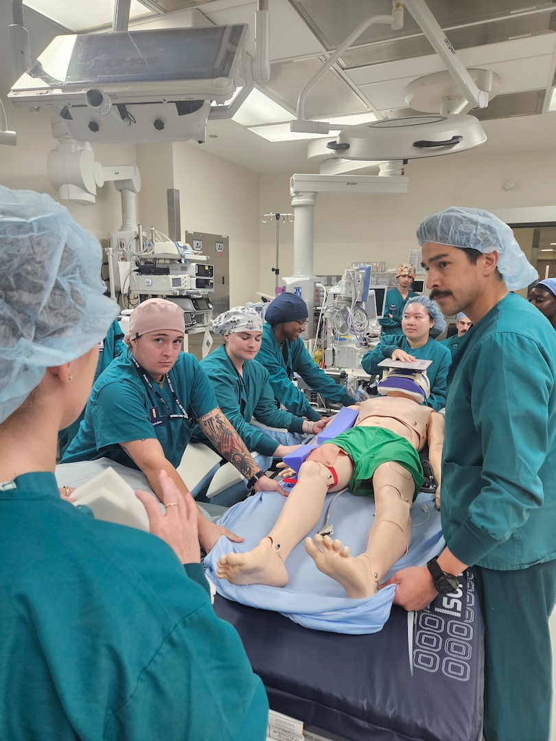 Clinicians and nursing staff assigned to David Grant Medical Center participate in pressure injury prevention training inside an operating room at Travis Air Force Base, Calif., May 2026. The training supports efforts by the Wound Care Optimization Team to reduce healthcare-acquired pressure injuries through standardized prevention practices and interdisciplinary collaboration. (U.S. Air Force photo)