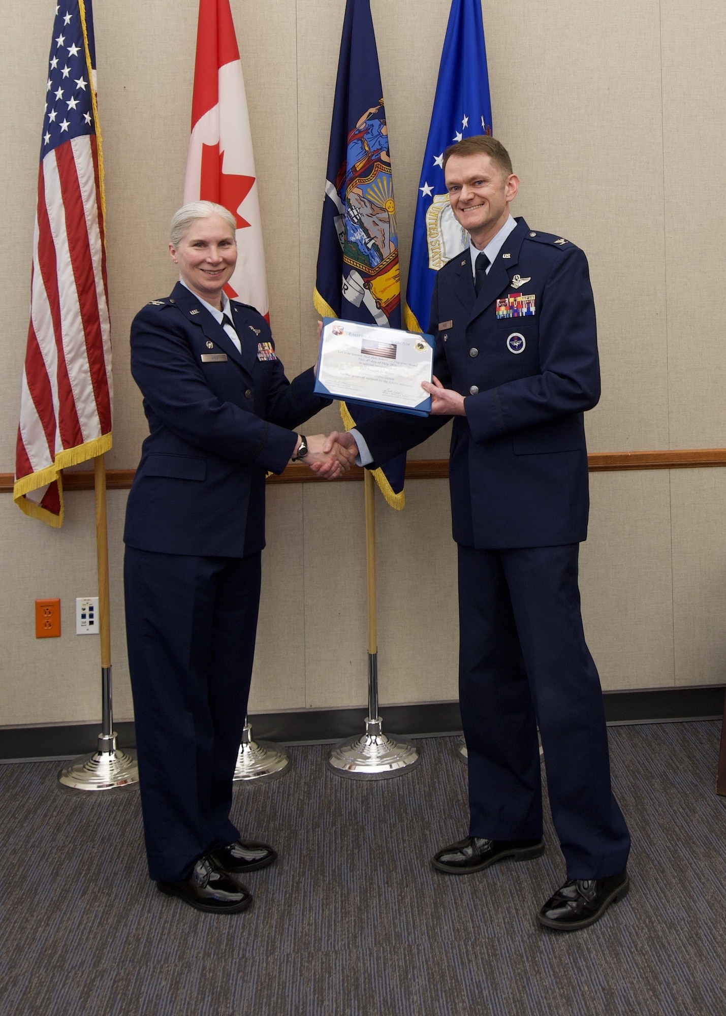 U.S. Air Force Col. Jennifer L. King, commander of the Eastern Air Defense Sector (EADS), and Col. Joseph F. Roos, former EADS commander, pose for a photo during Roos’s retirement ceremony in Rome, New York, May 12, 2026. During the ceremony, unit members honored Roos for his years of dedicated service and presented him with tokens of appreciation.