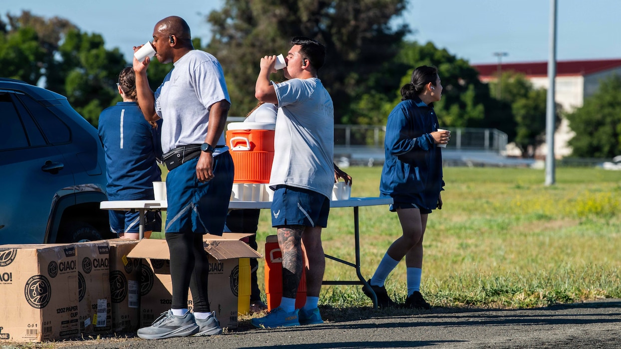Airmen stop for a drink of water during memorial run